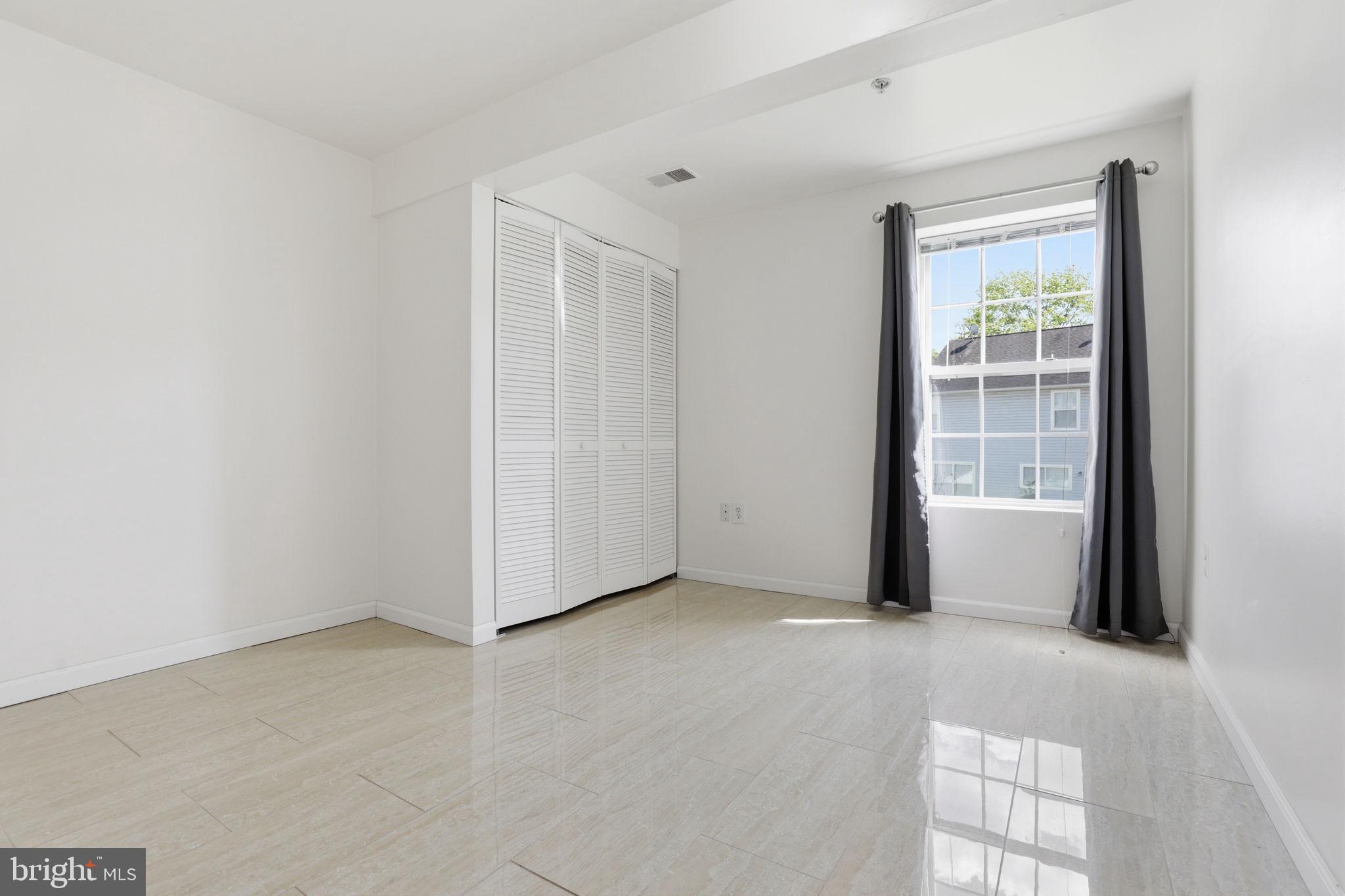 10105 Elgin Circle Bowie, MD 20721 - Photo 31 of 32 a view of an empty room with a window