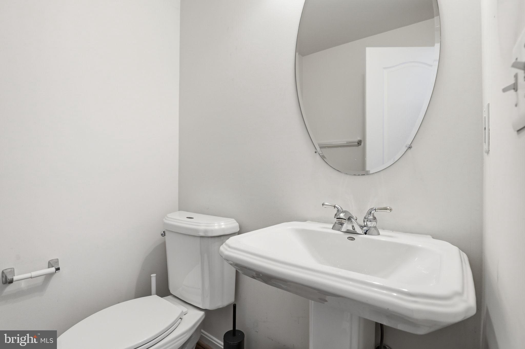 10105 Elgin Circle Bowie, MD 20721 - Photo 32 of 32 a white toilet sitting next to a bathroom sink