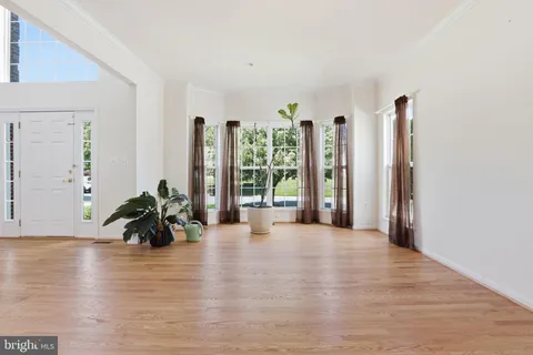 a view of a room with furniture and wooden floor