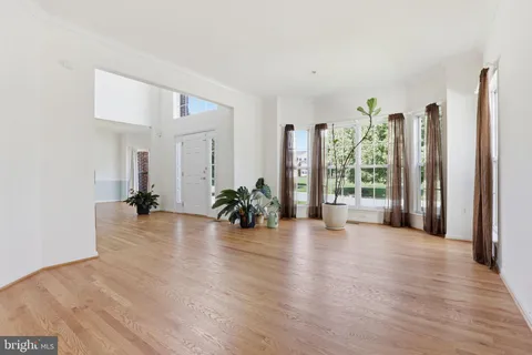 a view of a room with furniture and wooden floor