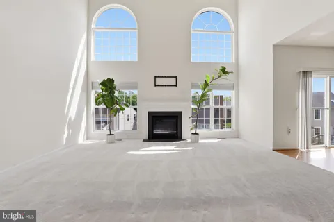 a view of an empty room with a fireplace and a window