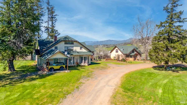 a view of a house with swimming pool and sitting area