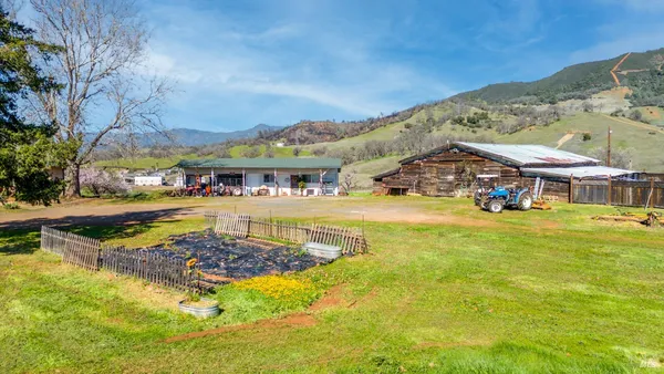 a view of a house with swimming pool and a yard
