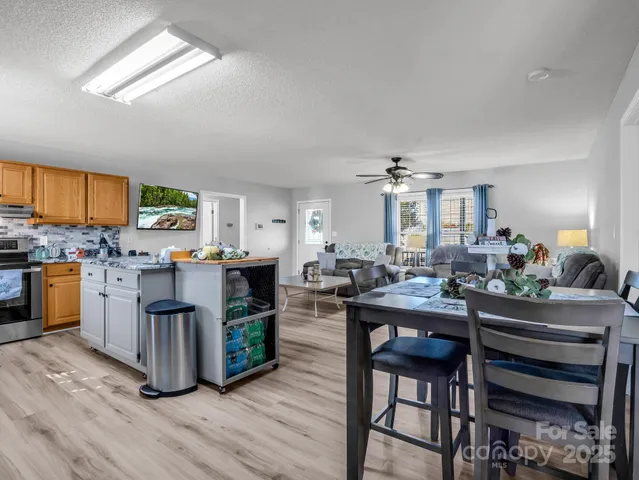 a kitchen with a table chairs refrigerator and cabinets