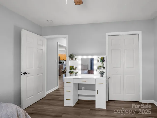 a view of a livingroom with wooden floor and a ceiling fan