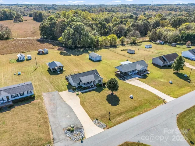 an aerial view of residential building with trees