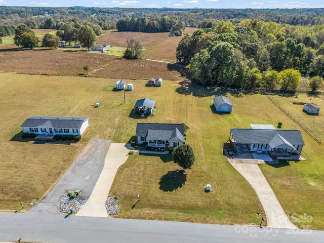 an aerial view of a house with a swimming pool
