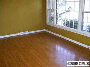 6924 Idlewild Road Charlotte, NC 28212 - Photo 2 of 5 a view of a room with wooden floor and windows