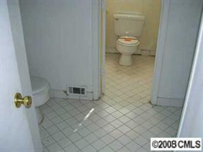 6924 Idlewild Road Charlotte, NC 28212 - Photo 5 of 5 a bathroom with a granite countertop toilet and a shower