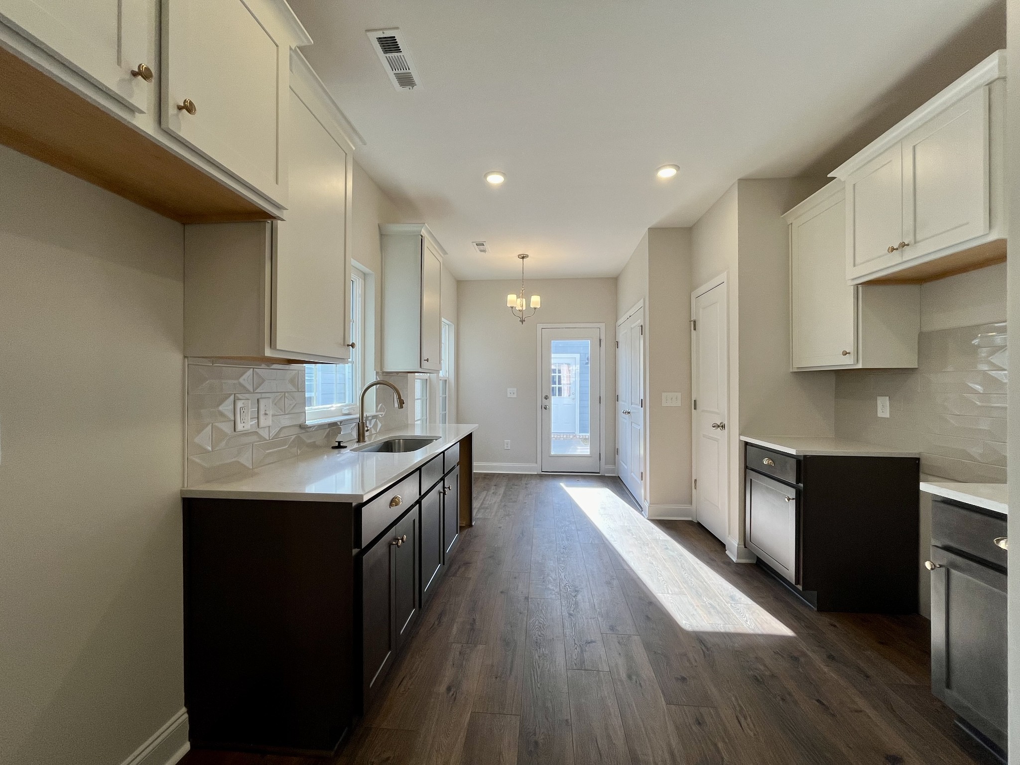 a kitchen with granite countertop a sink and cabinets