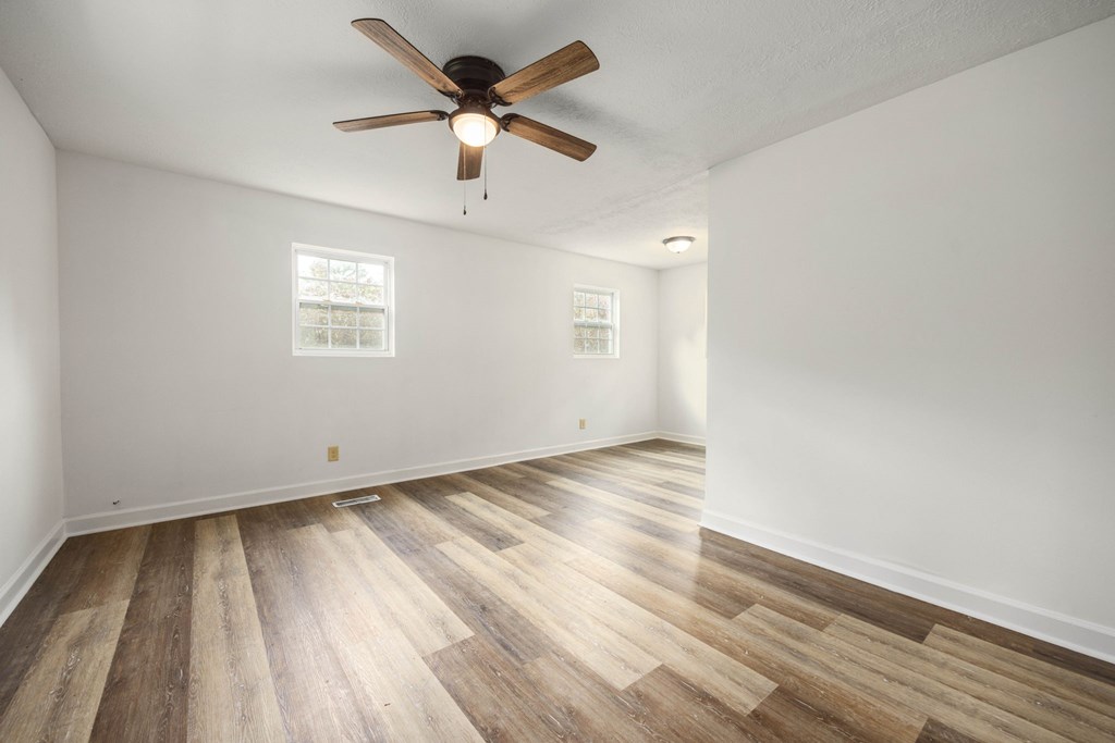 246 Sunnyside Church Road Pine Mountain, GA 31822 - Photo 4 of 26 an empty room with wooden floor and windows