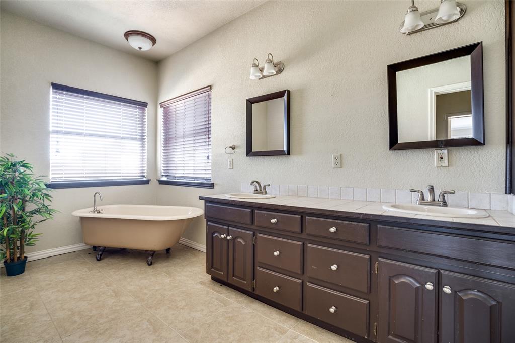 211 Bayne Road Haslet, TX 76052 - Photo 11 of 18 a spacious bathroom with a granite countertop tub sink and mirror
