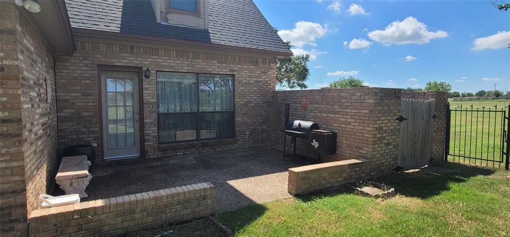 211 Bayne Road Haslet, TX 76052 - Photo 15 of 18 a brick house with potted plants in front of it