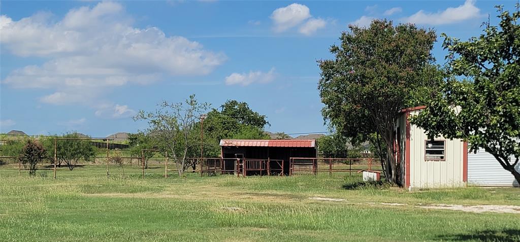 211 Bayne Road Haslet, TX 76052 - Photo 17 of 18 a backyard of a house with table and chairs