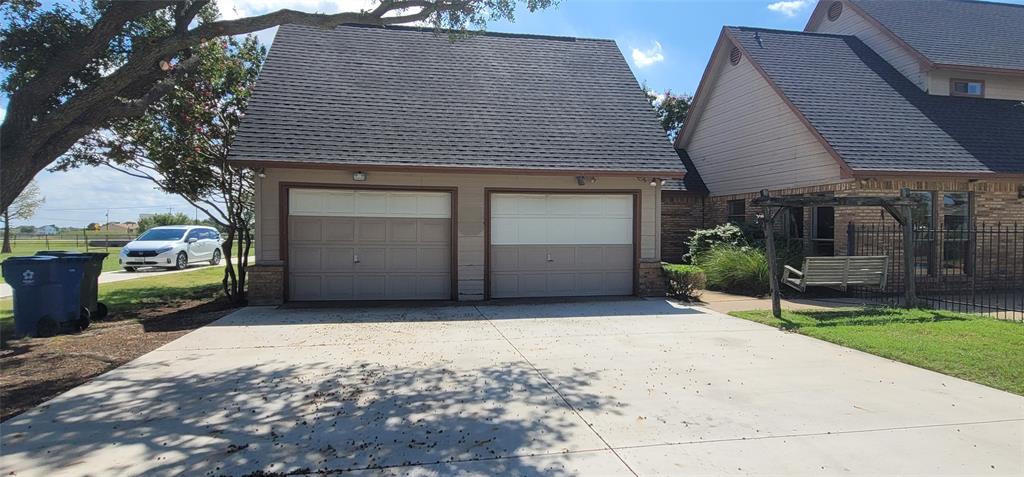 211 Bayne Road Haslet, TX 76052 - Photo 4 of 18 a front view of a house with a garden and plants