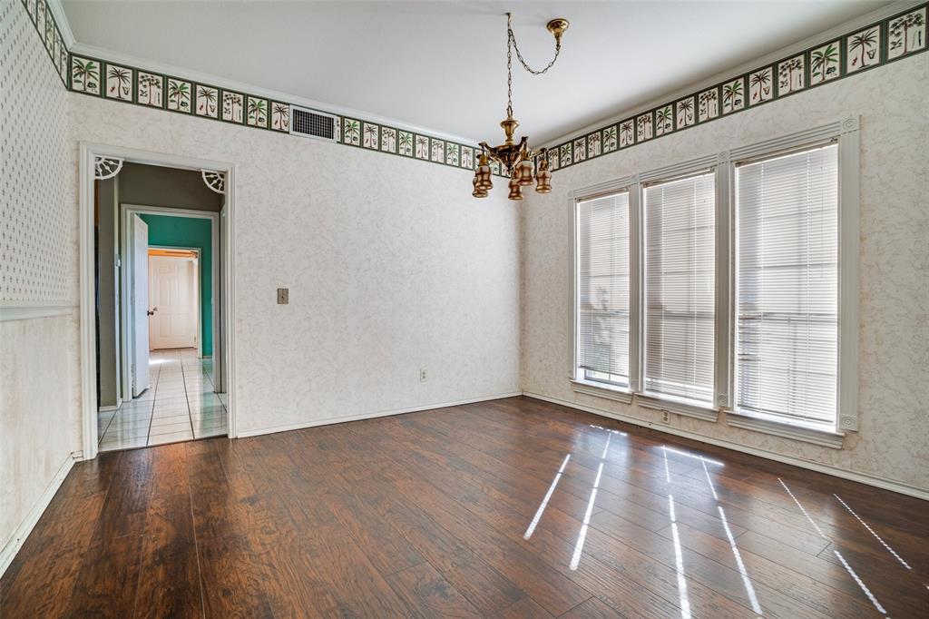 211 Bayne Road Haslet, TX 76052 - Photo 9 of 18 a view of an empty room with wooden floor fridge and a window