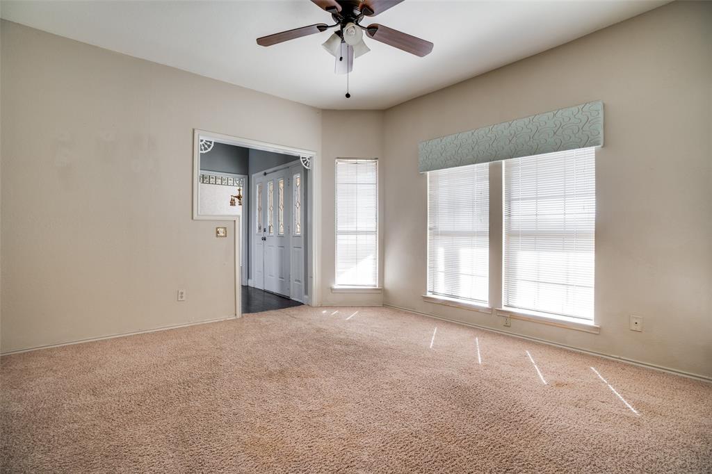 211 Bayne Road Haslet, TX 76052 - Photo 10 of 18 an empty room with chandelier fan and windows