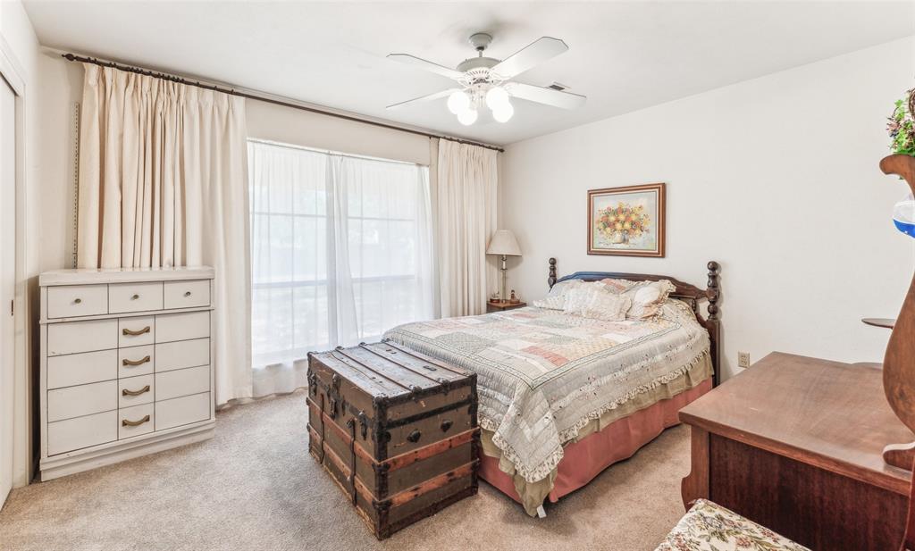 3055 Midway Road Grapevine, TX 76092 - Photo 15 of 40 a bedroom with a bed and a chandelier