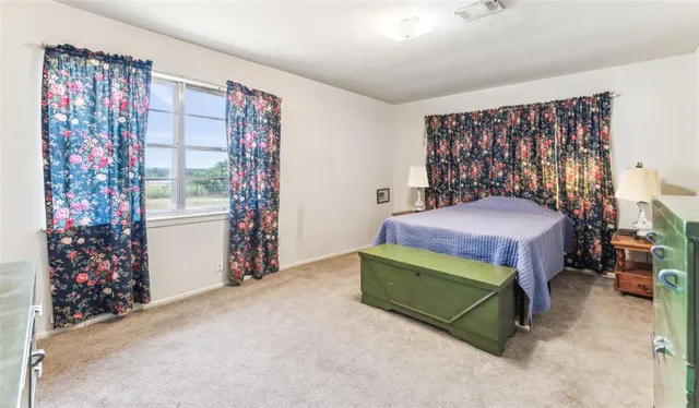 a bedroom with a bed and a chair