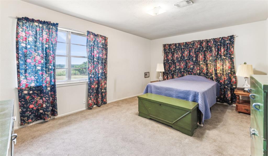 3055 Midway Road Grapevine, TX 76092 - Photo 16 of 40 a bedroom with a bed and a chair