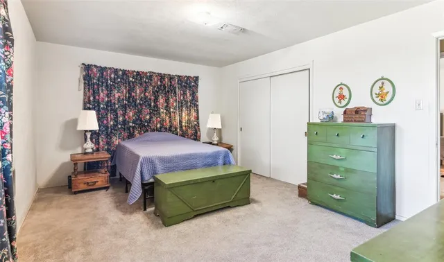 a bedroom with a bed and a dresser