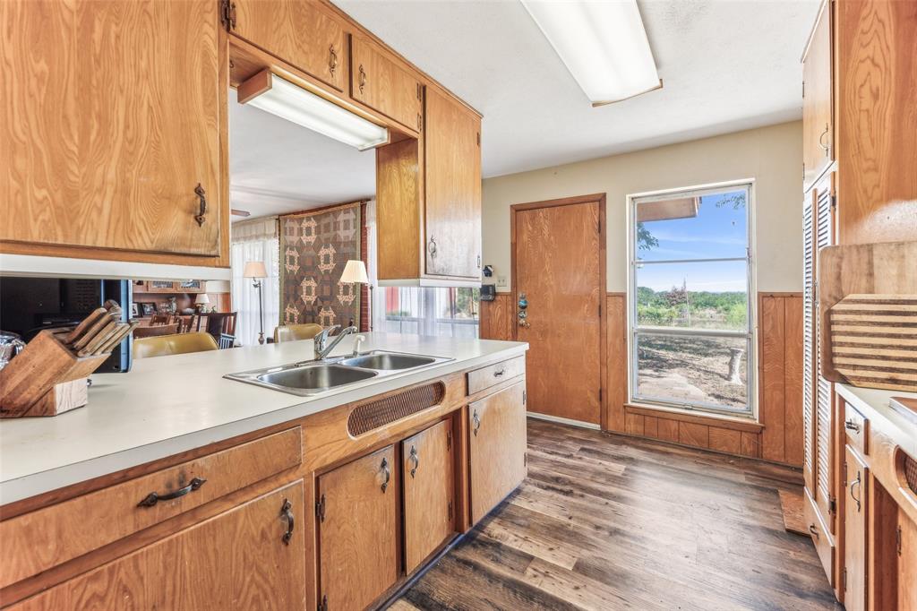 3055 Midway Road Grapevine, TX 76092 - Photo 27 of 40 a kitchen with stainless steel appliances granite countertop a sink stove and cabinets