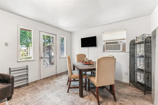 a work room with furniture a flat screen tv and windows