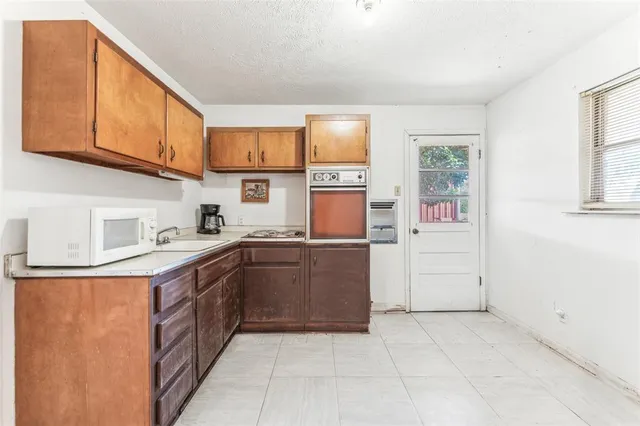 a kitchen with a sink cabinets and window