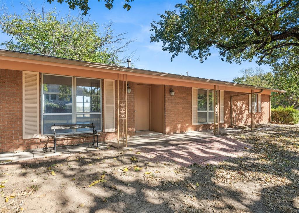 3055 Midway Road Grapevine, TX 76092 - Photo 5 of 40 front view of a house with a large window and potted plants