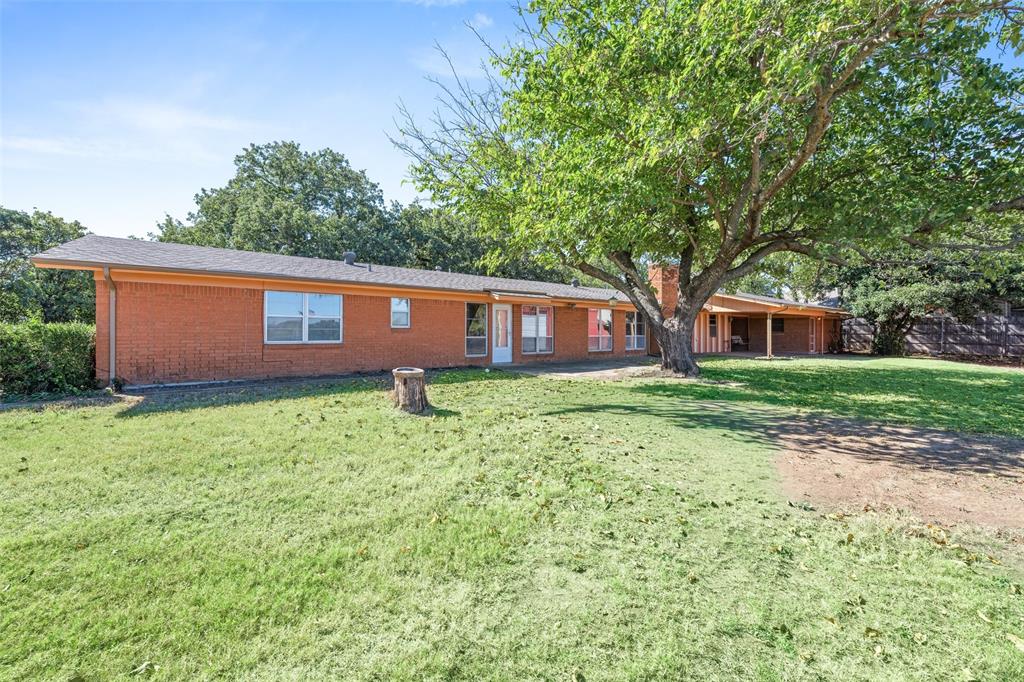 3055 Midway Road Grapevine, TX 76092 - Photo 7 of 40 a front view of a house with a garden