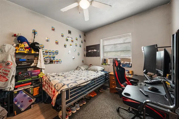 a bedroom with bed and a flat tv screen