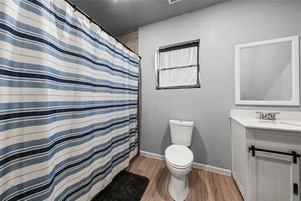 a bathroom with a sink a toilet and mirror