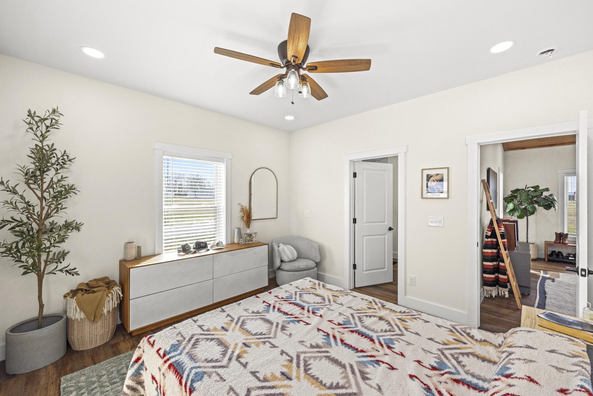 154 North Old Military Road Summertown, TN 38483 - Photo 17 of 45 a bedroom with a bed and a chandelier