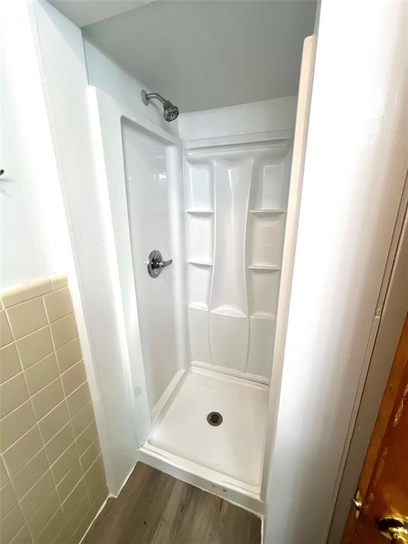 915 North Spring Street Grand Saline, TX 75140 - Photo 12 of 20 a bathroom with a glass door shower