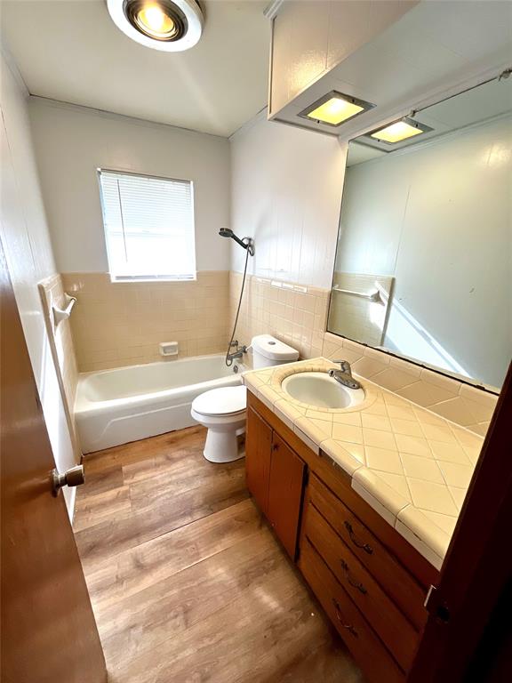 915 North Spring Street Grand Saline, TX 75140 - Photo 15 of 20 a bathroom with a sink a toilet and bathtub