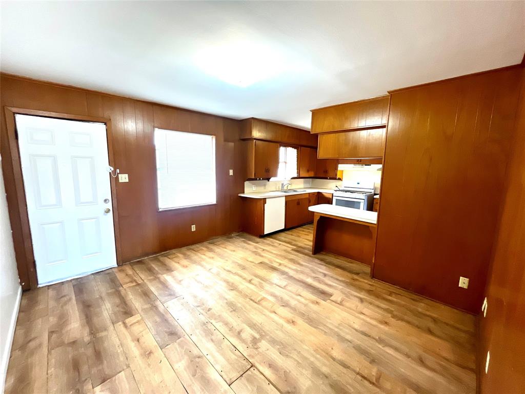 915 North Spring Street Grand Saline, TX 75140 - Photo 4 of 20 a view of a kitchen with wooden floor and electronic appliances