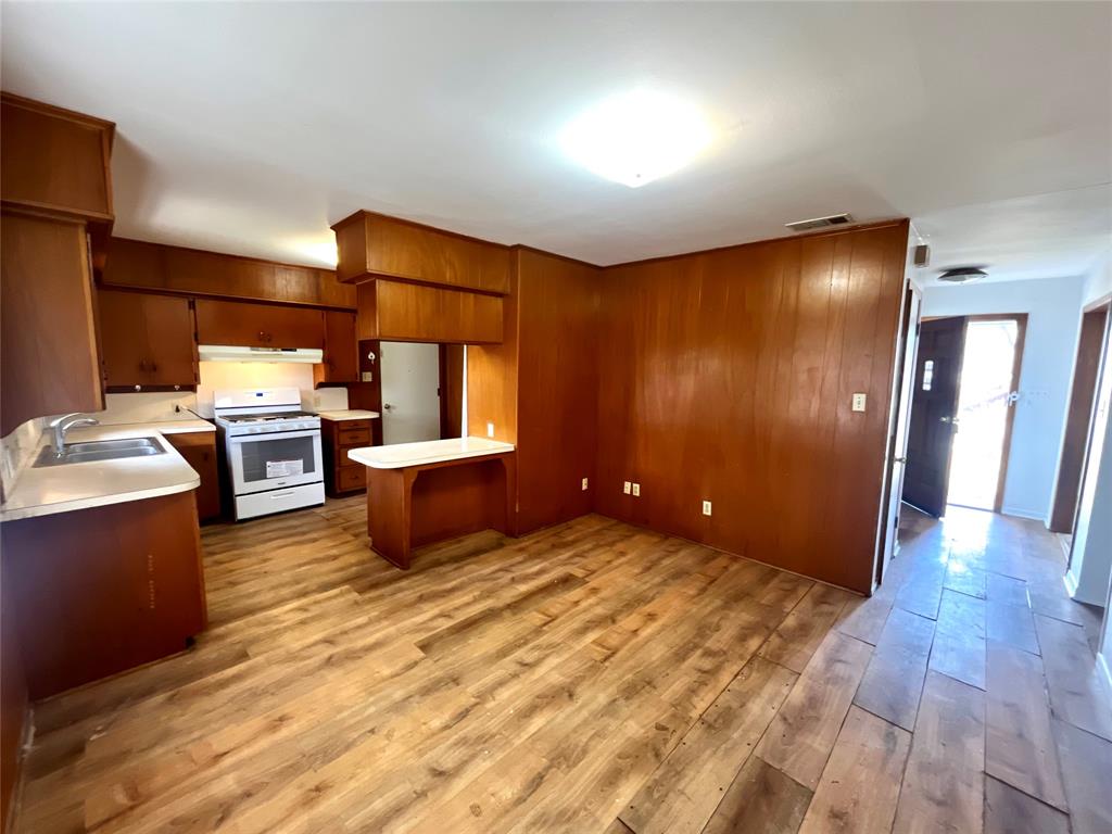 915 North Spring Street Grand Saline, TX 75140 - Photo 6 of 20 a kitchen with granite countertop a sink and stainless steel appliances
