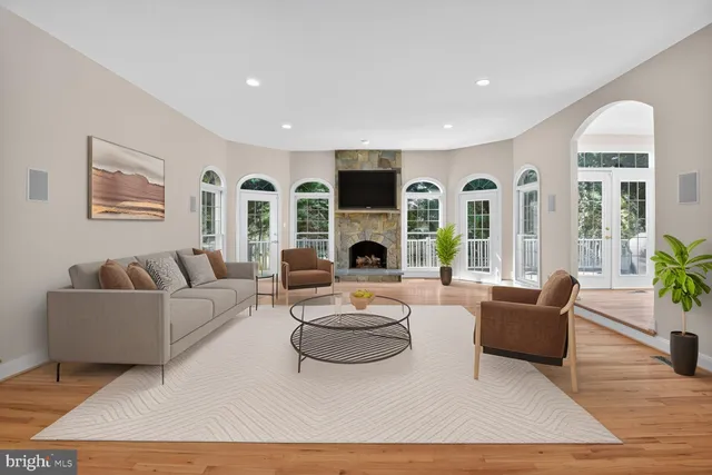 a living room with furniture a rug and a table