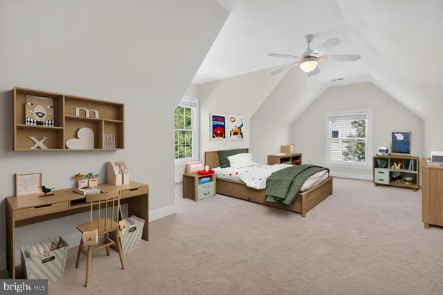 a bedroom with a bed a table and chair