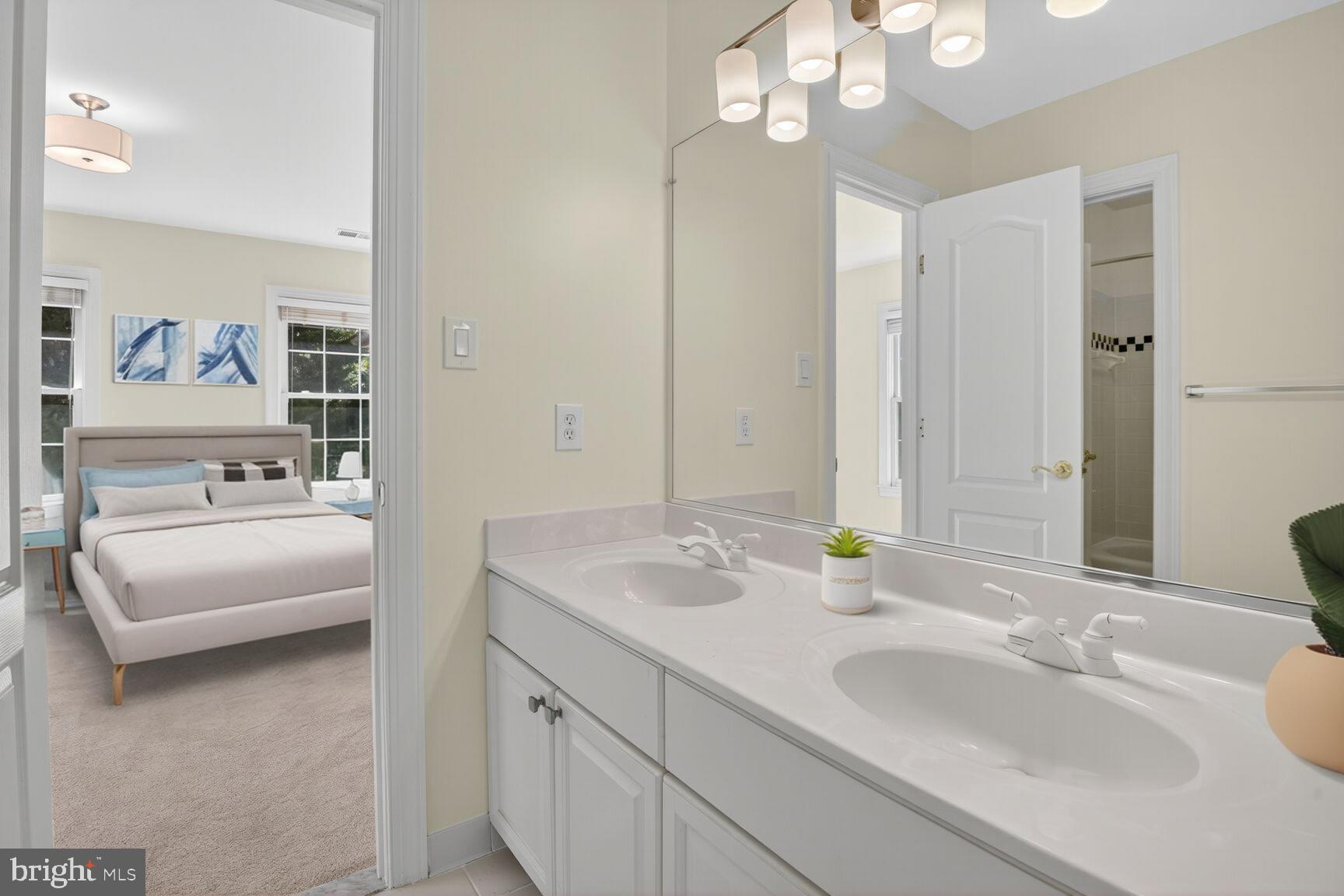 9914 Woodford Road Potomac, MD 20854 - Photo 18 of 87 a en suite bathroom with a sink double vanity and a mirror