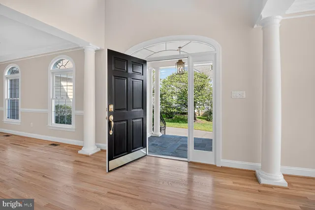 a view of entryway and hall with wooden floor