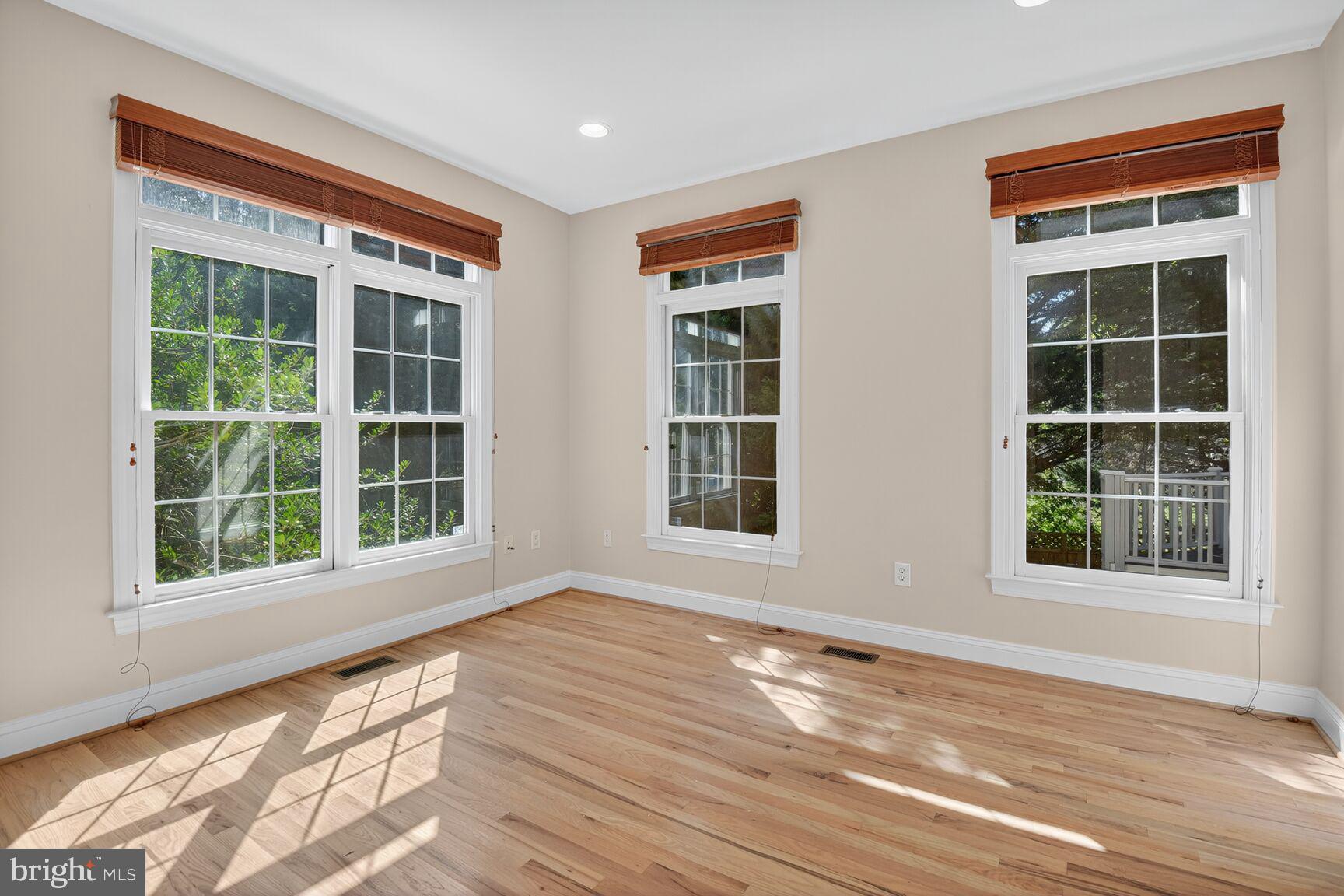 9914 Woodford Road Potomac, MD 20854 - Photo 31 of 87 a view of an empty room with wooden floor and windows