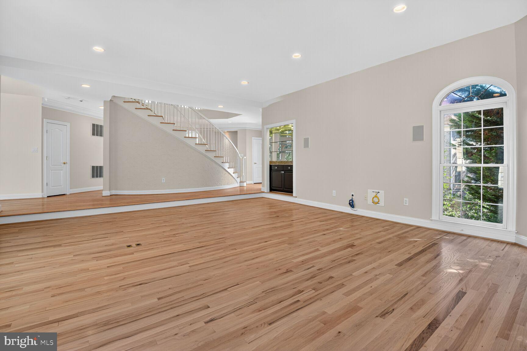 9914 Woodford Road Potomac, MD 20854 - Photo 35 of 87 a view of an empty room with wooden floor and a window