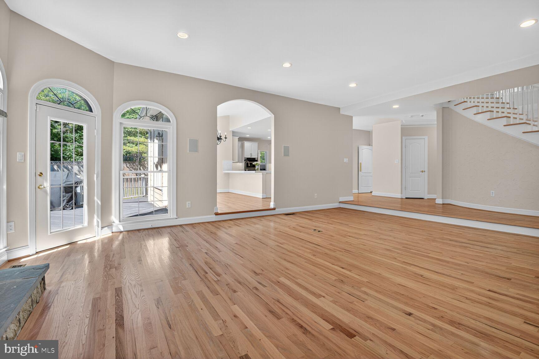 9914 Woodford Road Potomac, MD 20854 - Photo 36 of 87 a view of an empty room with wooden floor and windows