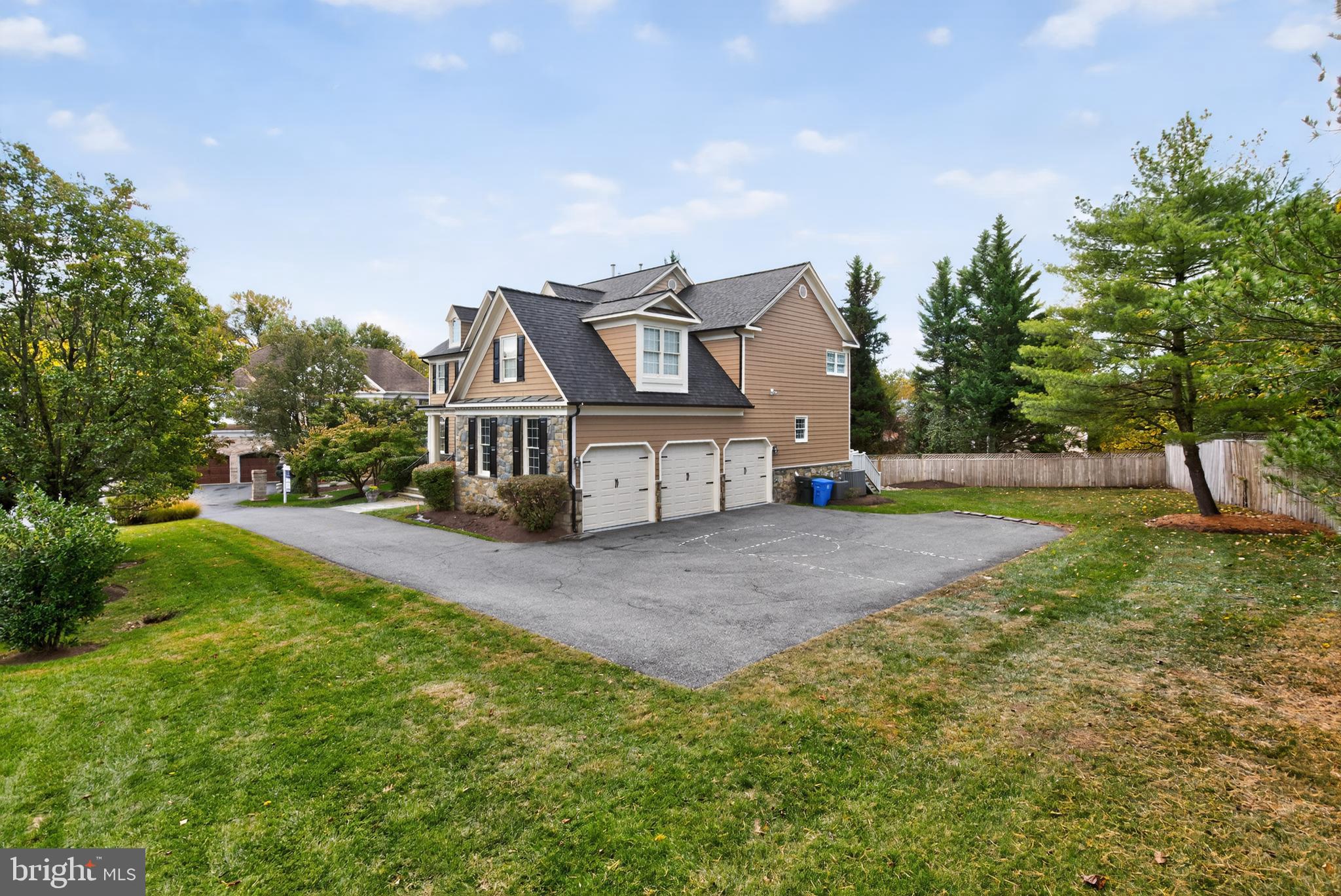 9914 Woodford Road Potomac, MD 20854 - Photo 4 of 87 a front view of a house with a yard and trees