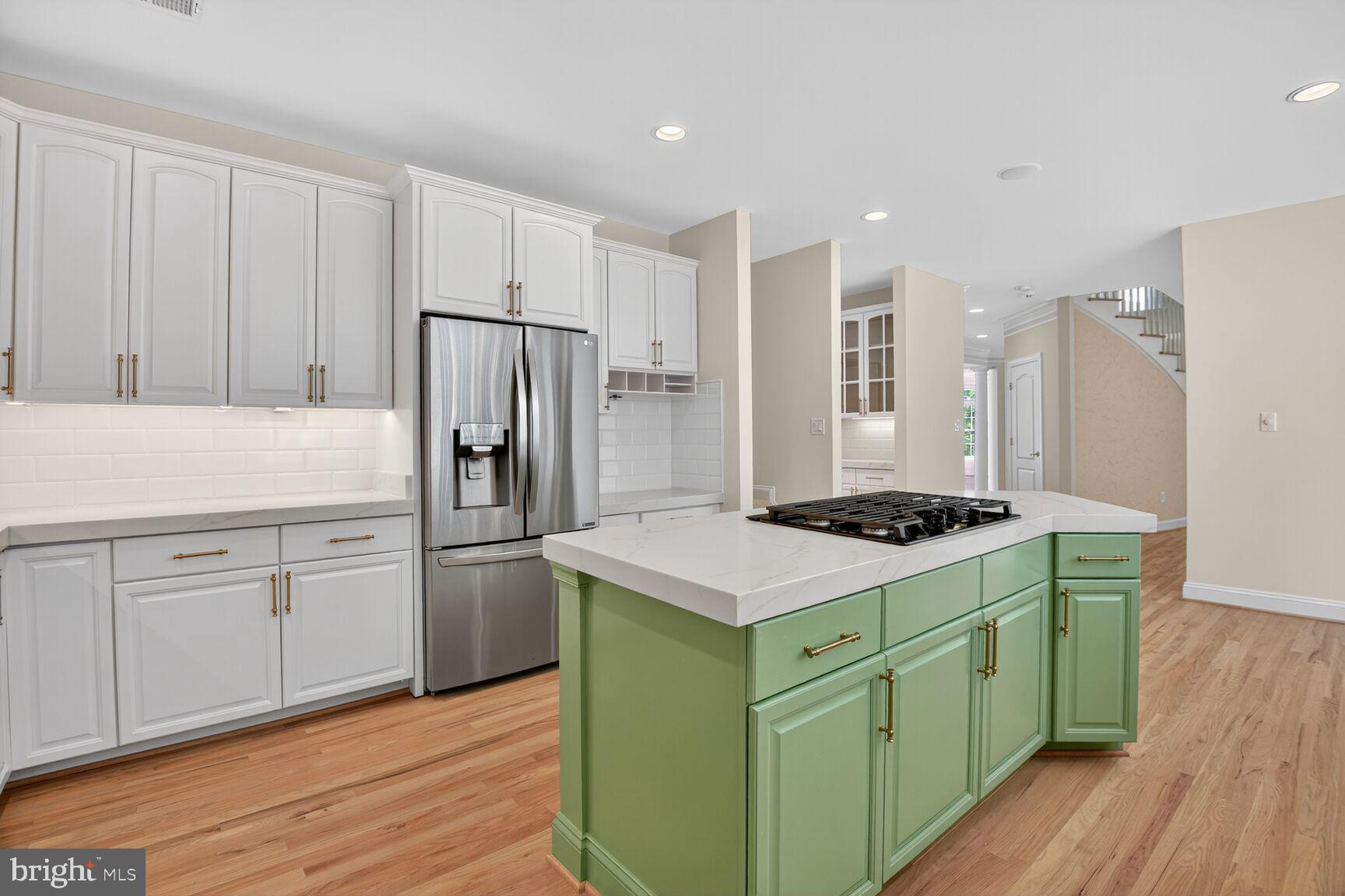 9914 Woodford Road Potomac, MD 20854 - Photo 47 of 87 a kitchen with white cabinets and stainless steel appliances