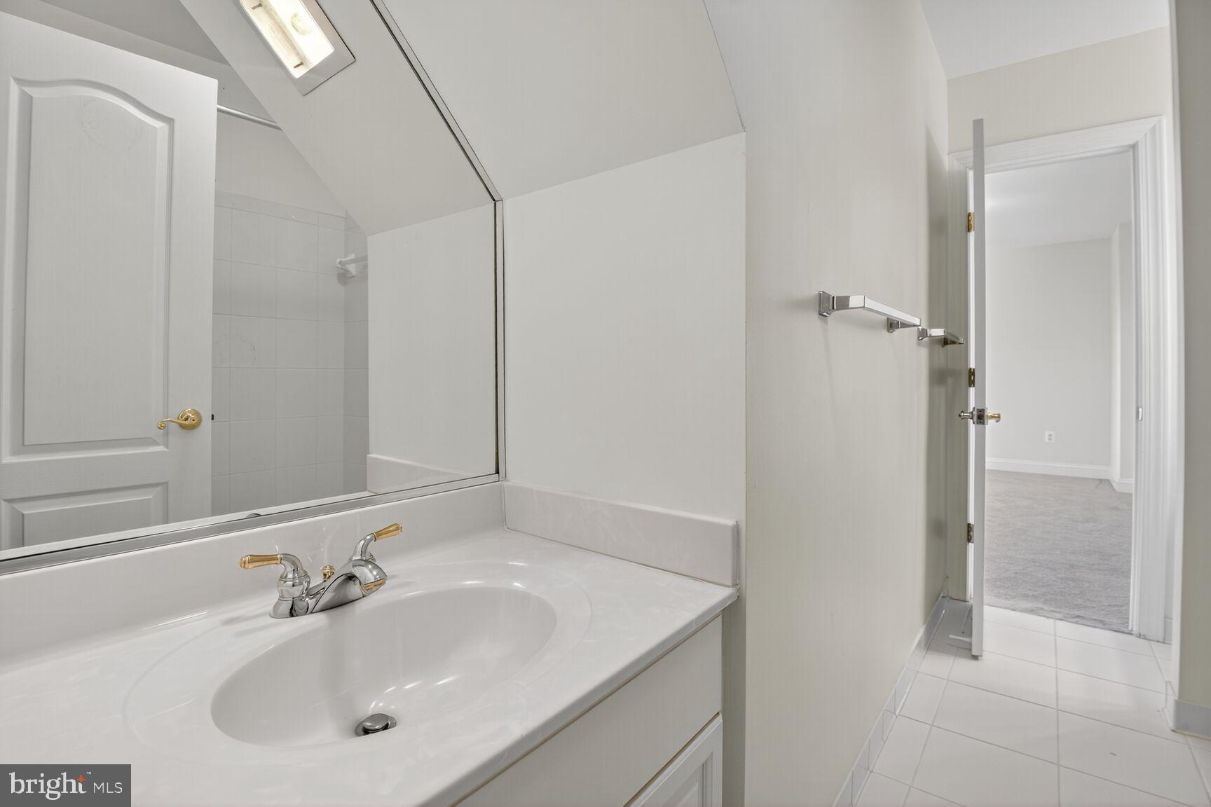 9914 Woodford Road Potomac, MD 20854 - Photo 54 of 87 a bathroom with a sink and a mirror