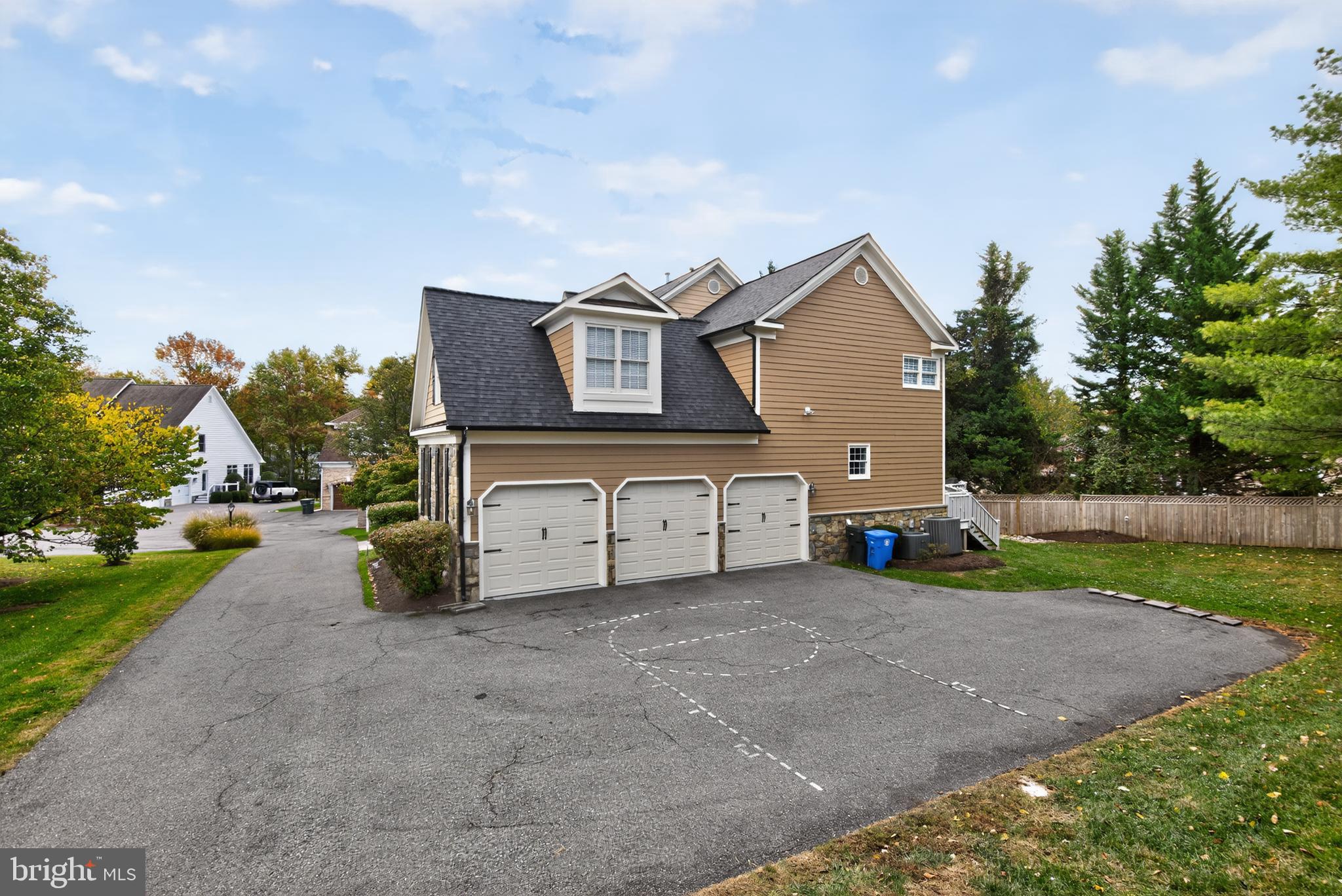 9914 Woodford Road Potomac, MD 20854 - Photo 7 of 87 a view of a house with a yard and a garage