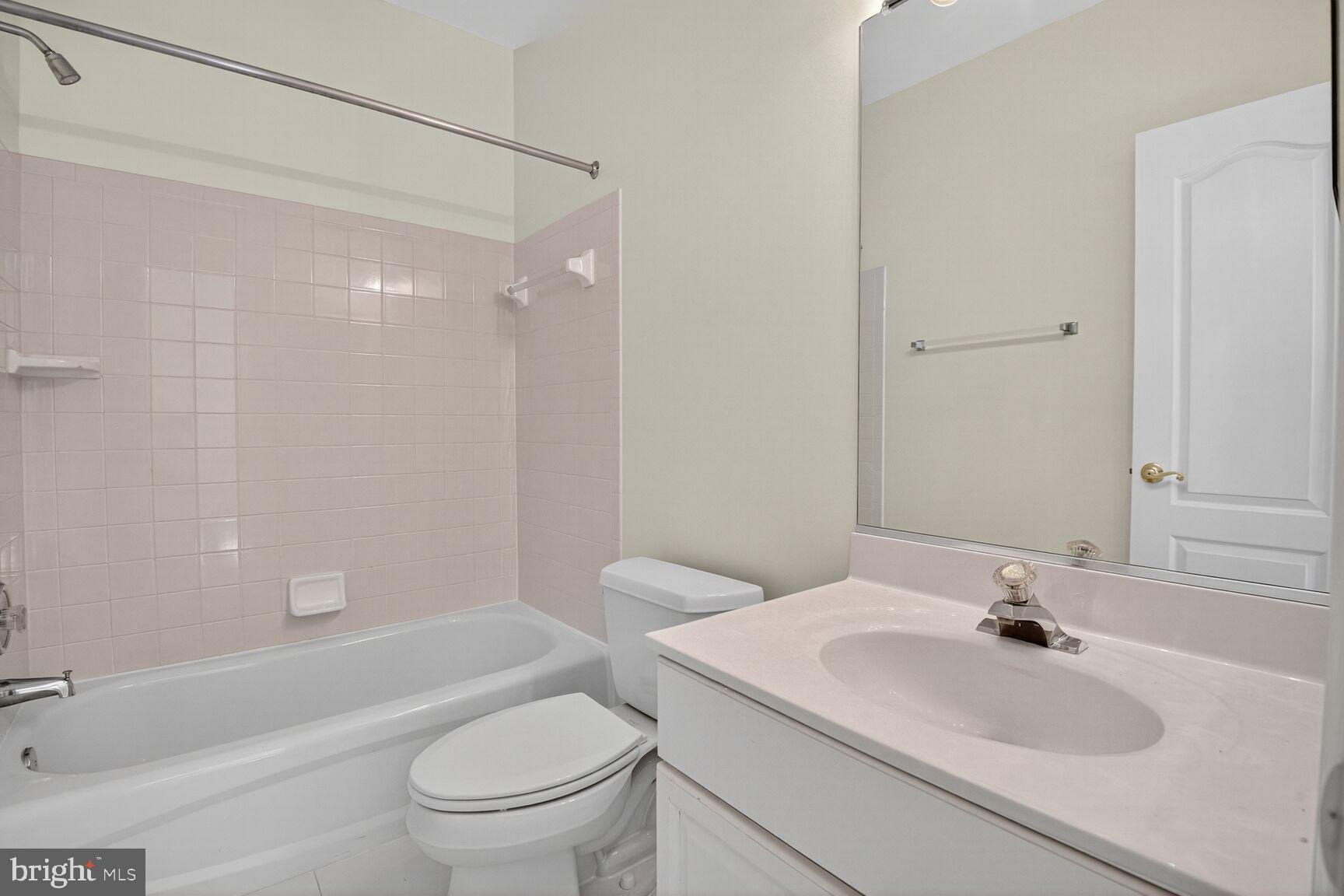 9914 Woodford Road Potomac, MD 20854 - Photo 73 of 87 a bathroom with a sink toilet and a bathtub