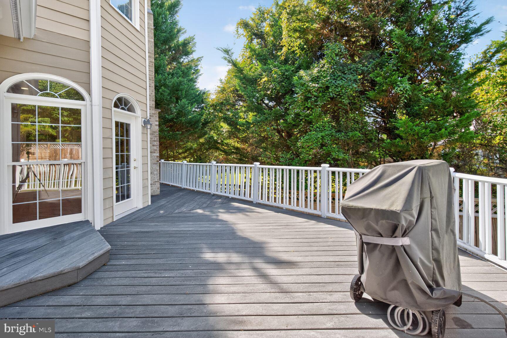 9914 Woodford Road Potomac, MD 20854 - Photo 80 of 87 a view of a roof deck with wooden floor and fence